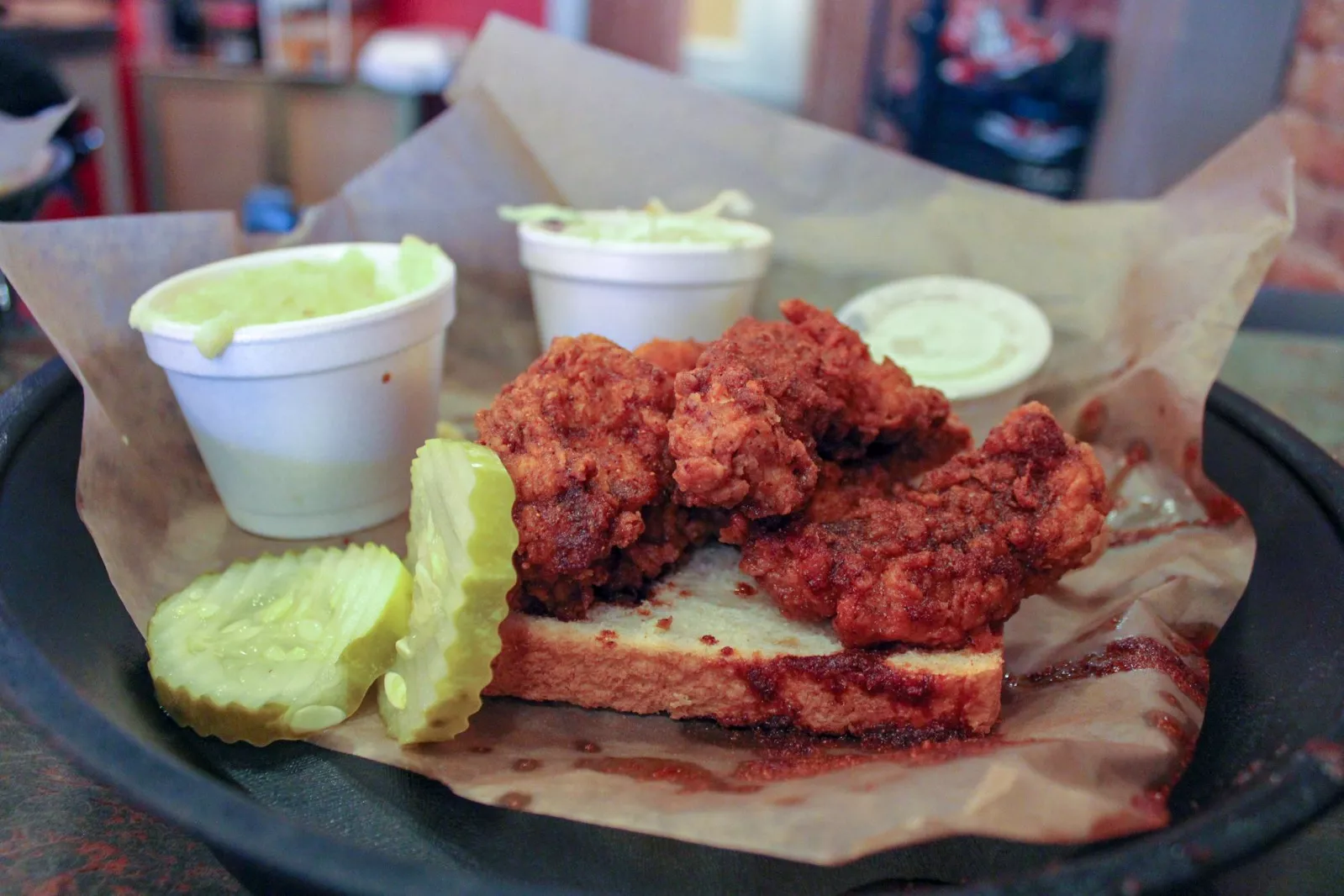 Lamon’s Nashville hot chicken tenders with pickles and Southern sides